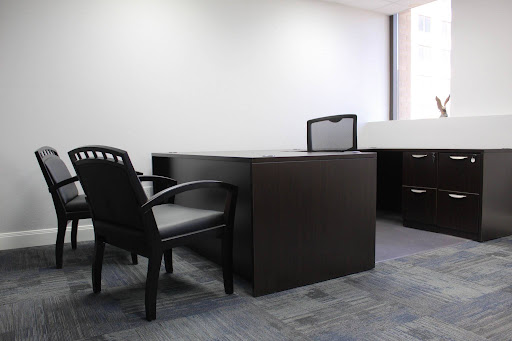 Private office with a wood desk and filing cabinets ensuring privacy for clients